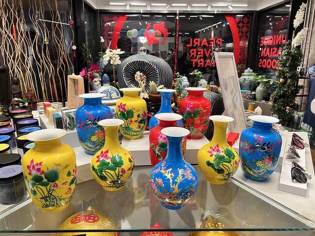 Yellow, blue, and red vases with flowers on display at Pearl River Mart's Chelsea Market store