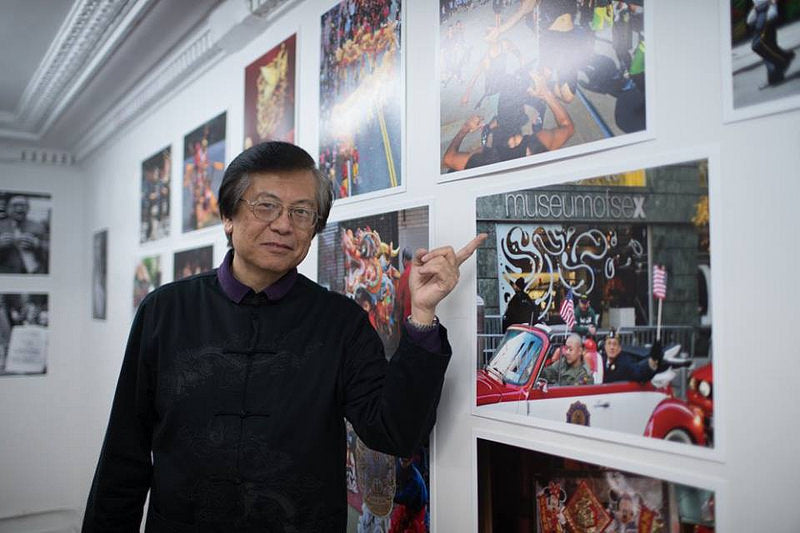 Photographer Corky Lee pointing at Museum of Sex photo in the Pearl River Mart gallery in Tribeca