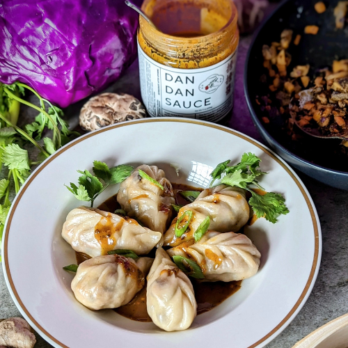 Dish of dumplings with Chinese Laundry Dan Dan sauce