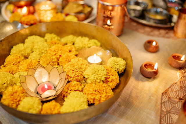 Bowl of yellow flowers and floating candles