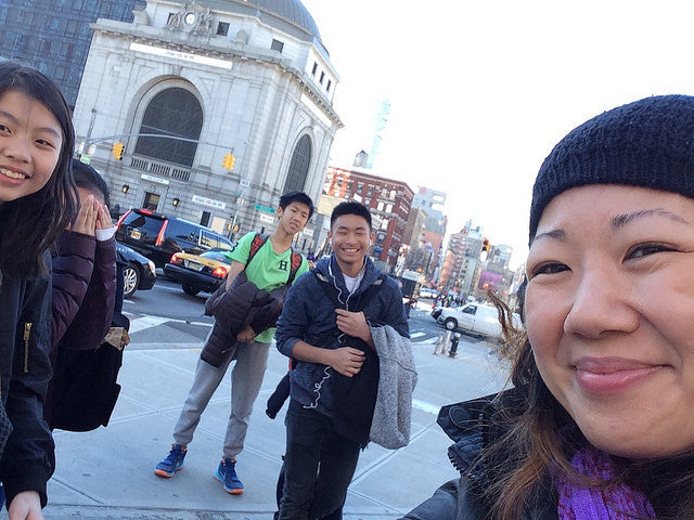 Teacher E-Anna Soong with her students on a street in Chinatown