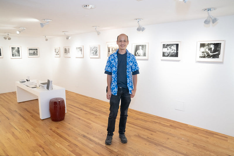 Photographer Ed Cheng in Pearl River Mart's art gallery with pieces from his exhibition