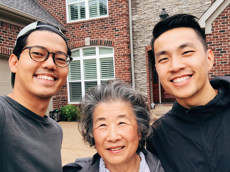 Photographers Emanuel Hahn and Andrew Kung with retired librarian Frieda Quon in front of her home