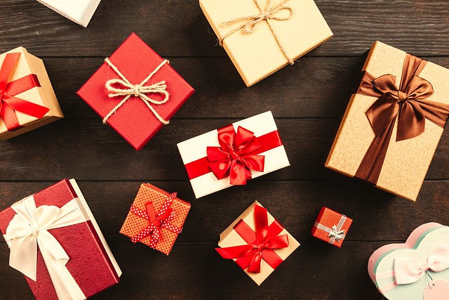 Array of red and gold wrapped gifts with ribbon