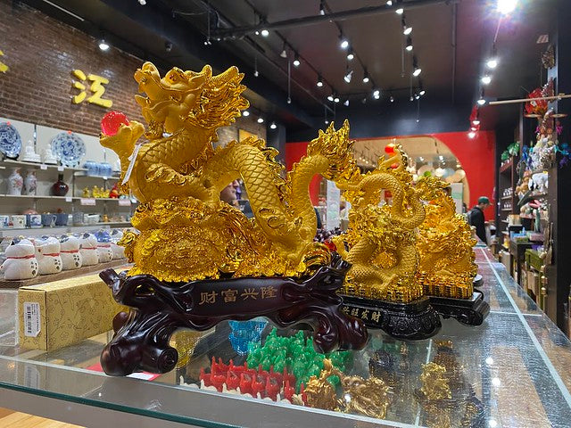 Large gold dragon figurine on shelf