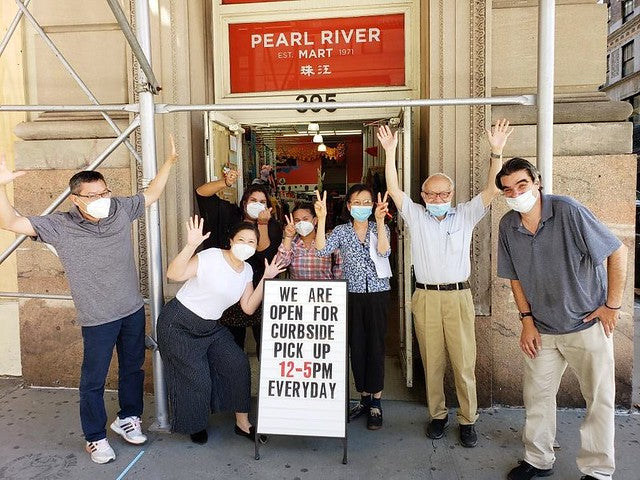 Group with masks in front of Pearl River Mart Tribeca after reopning