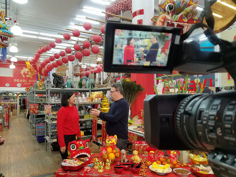 Pearl River Mart President Joanne Kwong talking to NY1's Roger Clark on camera
