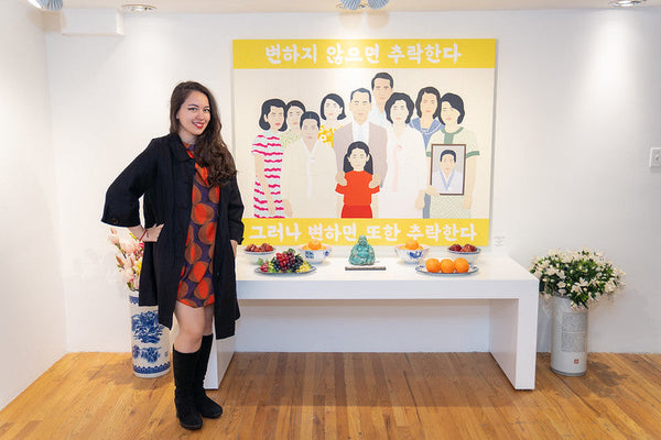 Artist Julia Chon beside her painting and altar table