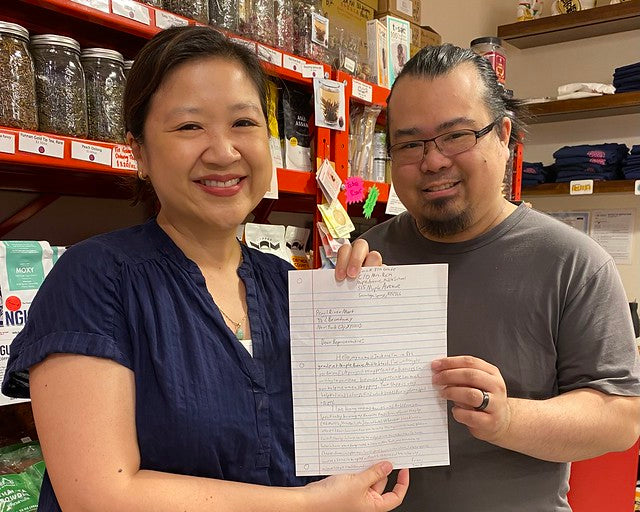 Joanne Kwong and Brian Lee holding student letter in Pearl River Mart Foods