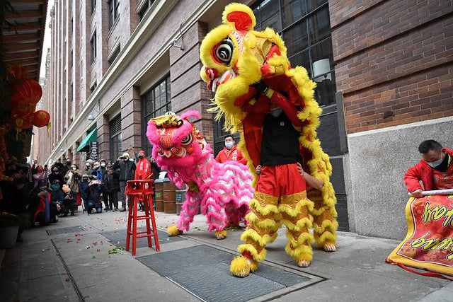 Lion dancers on 16th Street in front of Chelsea Market in NYC