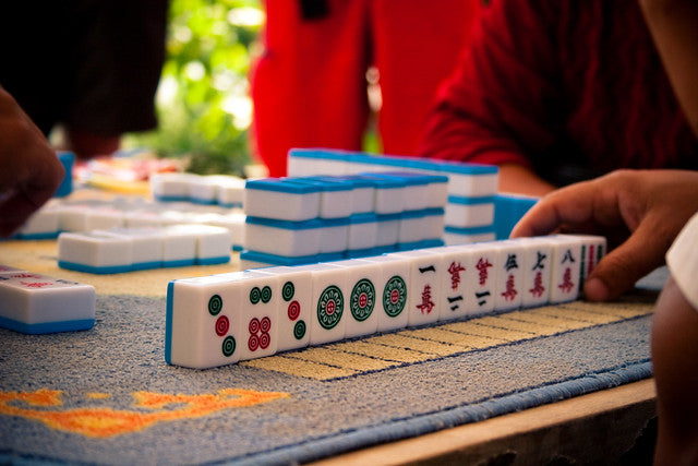 A player's mahjong hand on a table