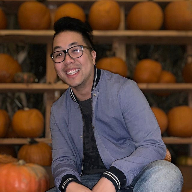 Mathew Wong in front of pumpkin display