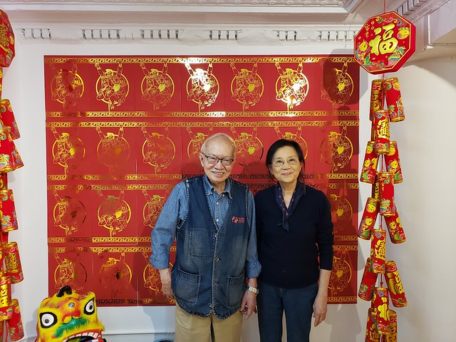 Mr. and Mrs. Chen in front of Jerry Ma's artwork