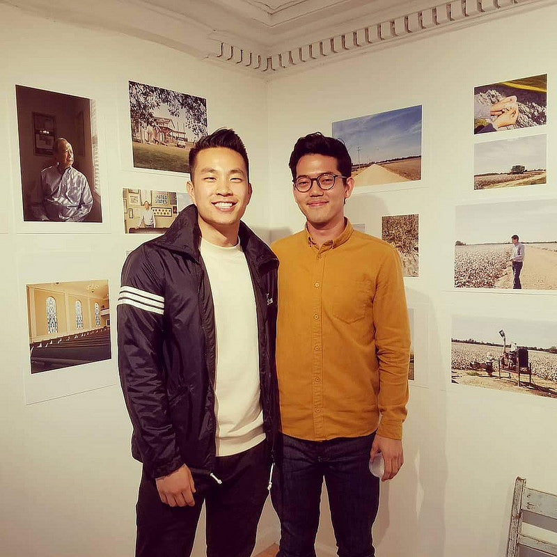 Photographers Andrew Kung and Emanuel Hahn in front of their photos in the Pearl River Mart gallery in Tribeca 