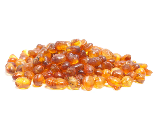 Pile of dried peach resin on white background