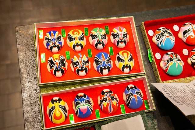 Display case with various colorful small Peking opera masks
