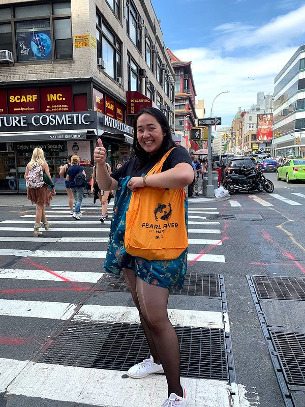 Pearl River Mart intern Pearl Ngai with yellow Pearl River bag in Chinatown