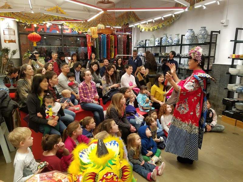 Magician GeGe performing for children in Pearl River Mart at Chelsea Market
