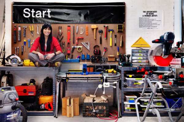 Artist Risa Puno in her workshop surrounded by tools and books