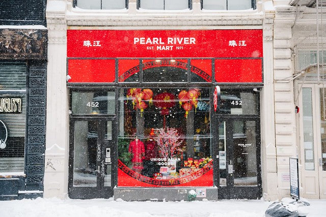 Store window of Pearl River Mart at 452 Broadway on snowy day