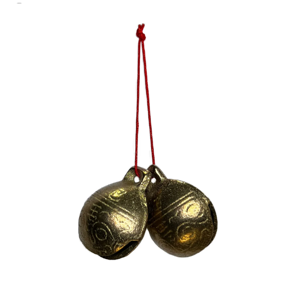 Two brass bells on red strings