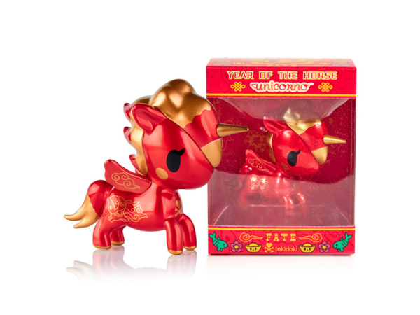 Red and gold unicorn figurine beside box