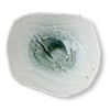 A square ceramic plate with a rustic, hand-painted finish, featuring a textured off-white glaze and a central dark green and white abstract swirl pattern, shown on a plain white background.