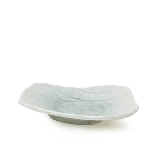 A small, shallow, organic shaped ceramic dish with a textured surface and a light gray base, shown on a plain white background.