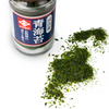 Smattering of seaweed flakes besides jar of Aonori (Seaweed Flakes)