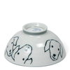 Ceramic bowl upside down, featuring cute, minimalist dog faces sketched in black. The white surface gives a clean, playful, and light-hearted tone.