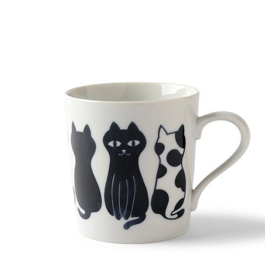 Ceramic mug with three stylized black and white cat illustrations side by side, each with a unique pattern, conveying a playful and charming tone.