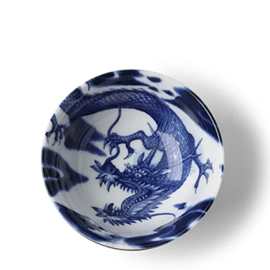 A round white ceramic bowl featuring a detailed blue dragon illustration, shown from a top-down perspective on a white background.