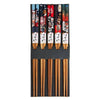 A set of five decorative chopsticks, each featuring a different colorful Japanese-style illustration including cats, stars, waves, and cherry blossoms, with white paper bands displaying Japanese text near the wooden handles.