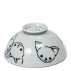 White ceramic bowl upside down featuring black line drawings of cute chihuahua faces, conveying a playful and cheerful tone.