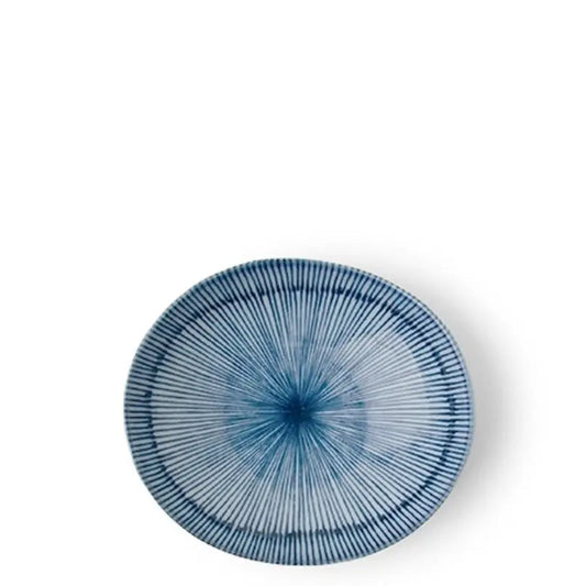 An oval ceramic plate with a blue and white radial starburst pattern, photographed from directly above on a white background.