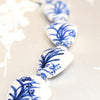 Close up of blue on white vase-shaped beads