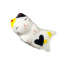 Ceramic cat-shaped object with yellow, white, and black colors on a white background.