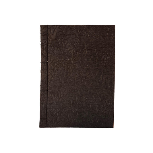 Black textured notebook on a white background