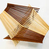 Folding basket made with 30 pairs of natural and tea stained colored chopsticks in a quad pattern