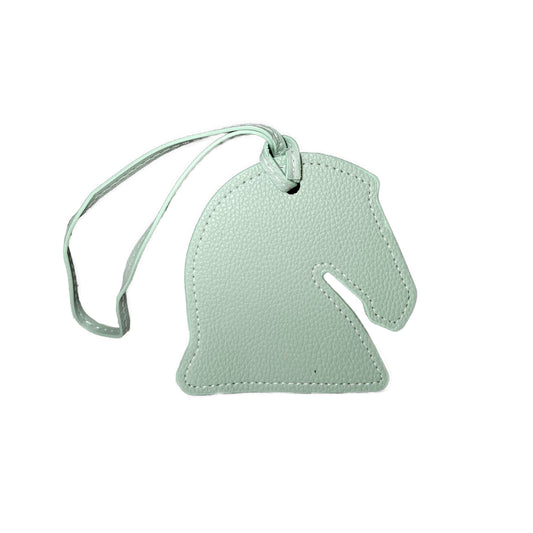 White horse head-shaped luggage tag on a white background