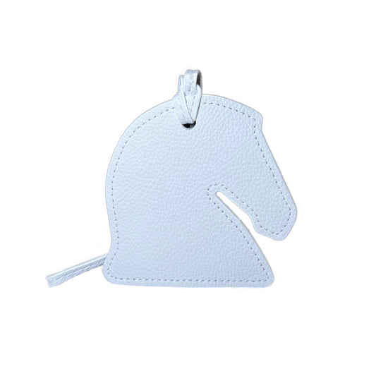 Light green horse-shaped luggage tag on a white background