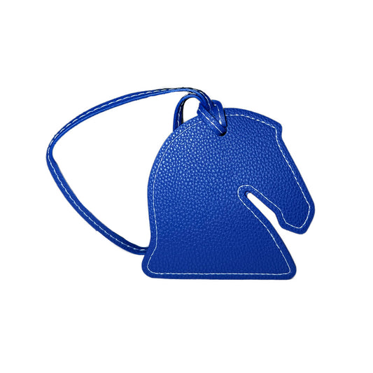 Blue horse-shaped luggage tag on a white background