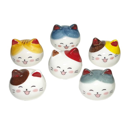 Array of colorful cat head-shaped chopstick rests