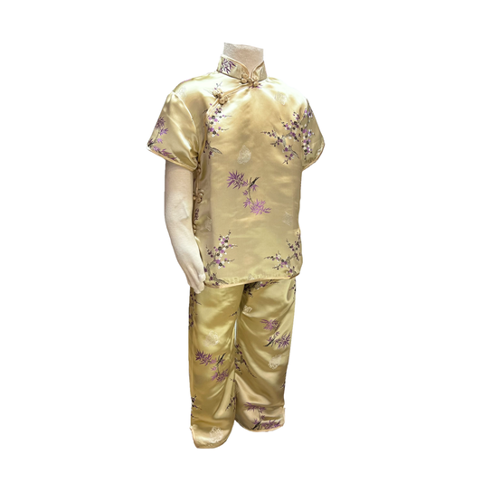 Traditional kids outfit in gold with purple bamboo and floral design on mannequin