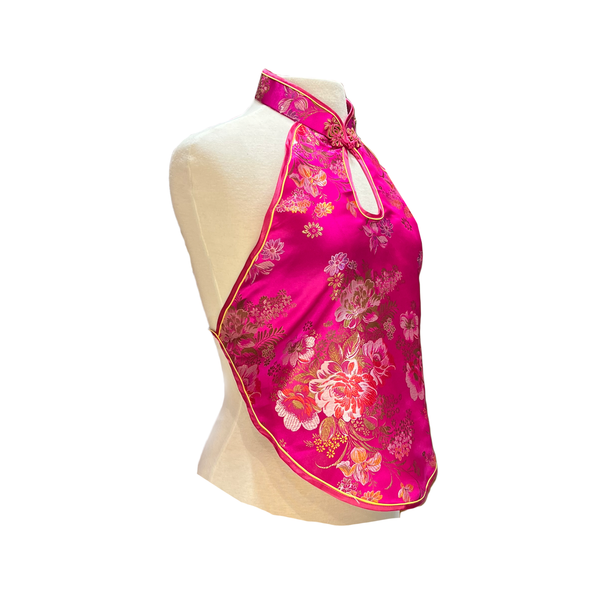 Pink floral halter top on a mannequin against a white background