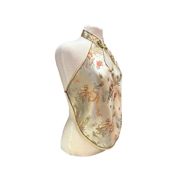 Decorative halter top with floral and dragon designs on a mannequin against a white background