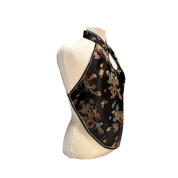 Black halter top with colorful dragons and phoenixes on a mannequin against a white background