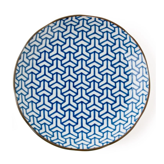 Round plate with blue and white geometric pattern on a white background