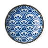 Ceramic plate with blue and white geometric pattern on a white background