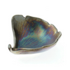 Ceramic leaf-shaped dish with a multicolored glaze on a white background